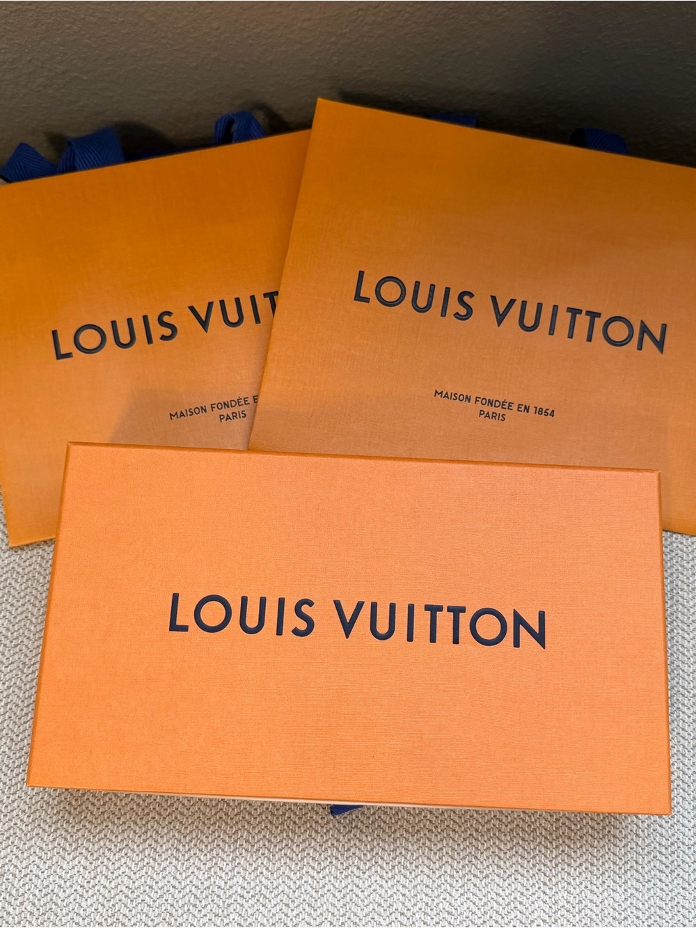 Louis Vuitton small box and 2 small shopping bags